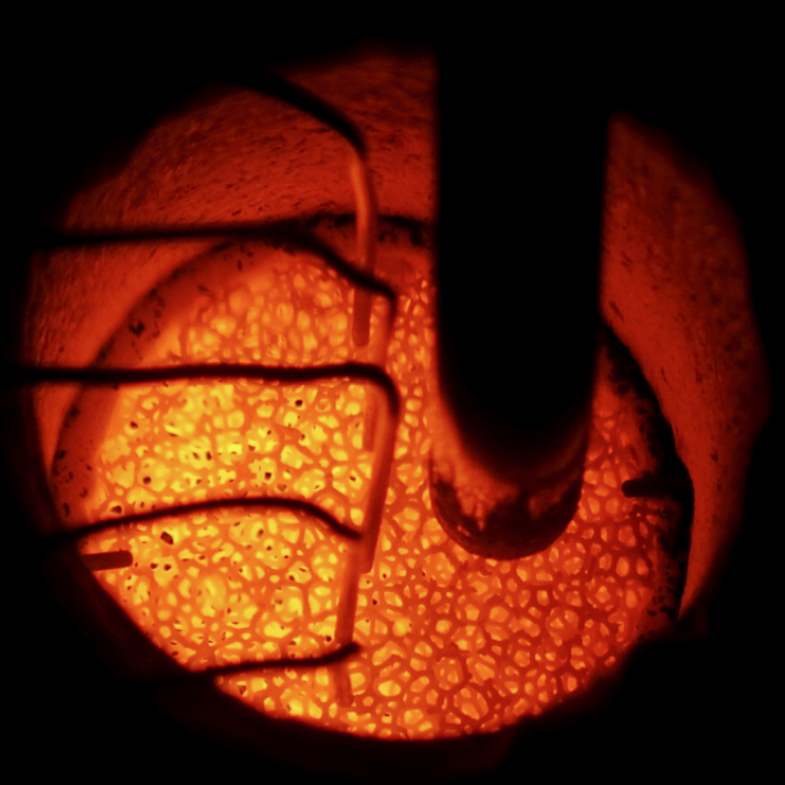 An operating porous-media burner with a glowing solid matrix during ammonia-hydrogen combustion